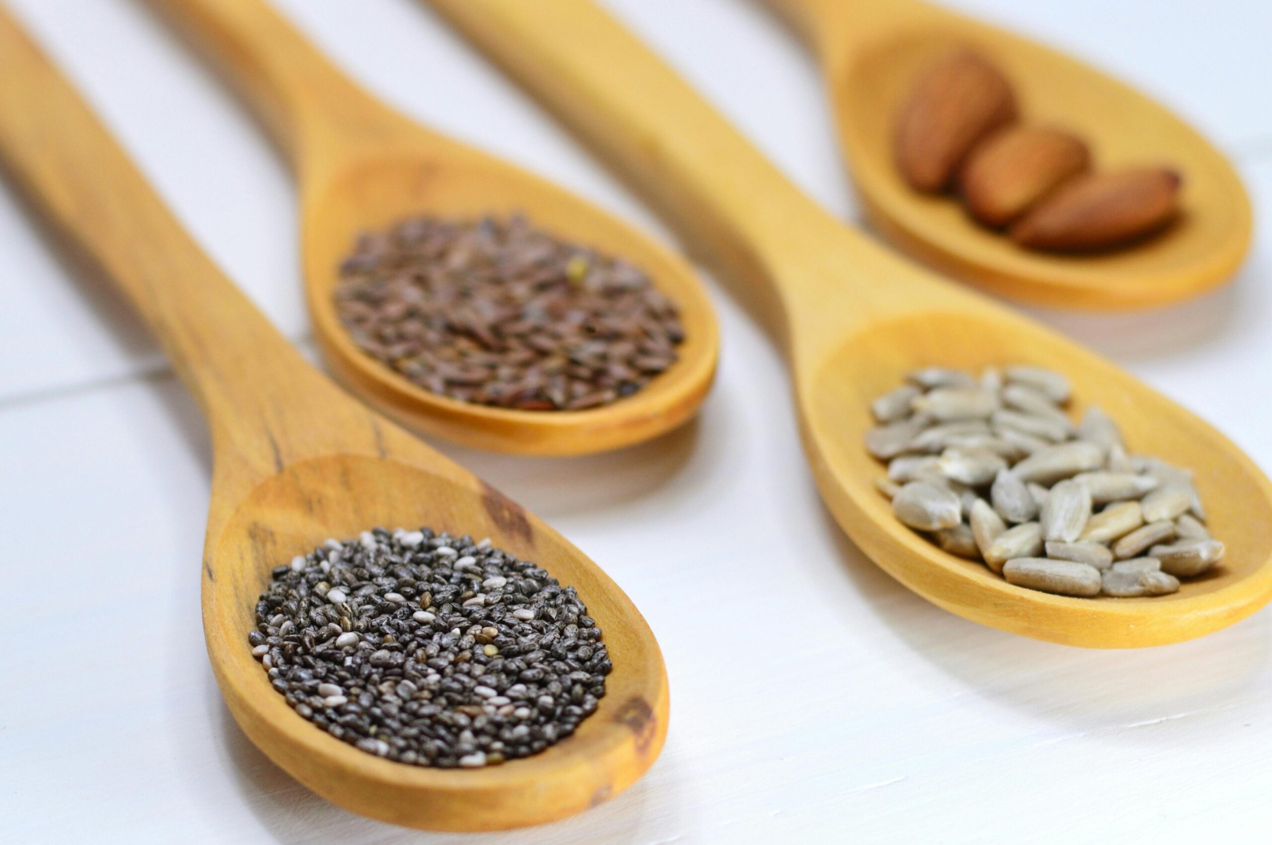 nuts and seeds in wooden spoons