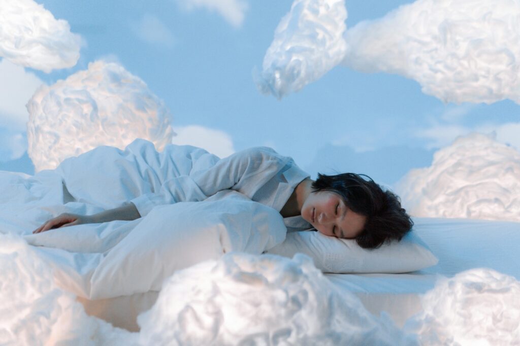 woman sleeping surrounded by clouds